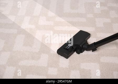 Vacuuming carpet. Clean area after using device, closeup Stock Photo