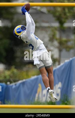 Los Angeles Rams safety Jason Taylor II, right, runs a play