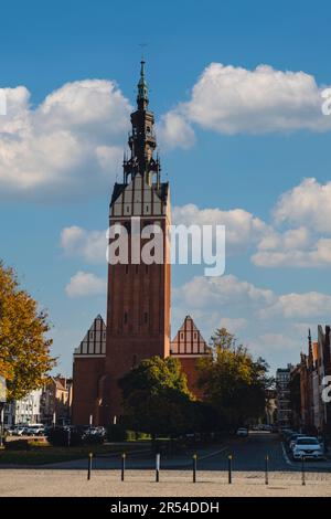Elblag, Poland - August 2022. St. Nicholas Cathedral Gothic tower View on the Market Gate and the main cathedral street of old town. Architecture of Elblag. City skyline Historical city in northern Poland. Travel destination tourist attraction Stock Photo
