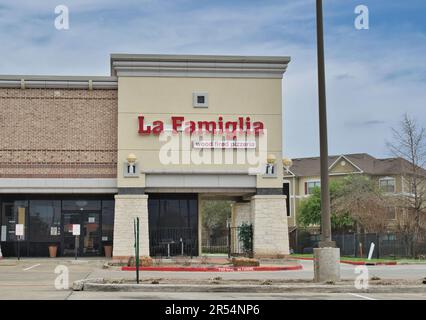 Humble, Texas USA 02-26-2023: La Famiglia wood fired pizzeria storefront exterior in a Humble, TX strip mall. Local pizza place restaurant. Stock Photo