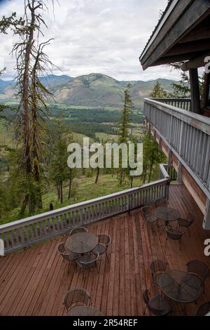 Outdoor dining tables overlook the Methow Valley, as seen from the deck of Sun Mountain Lodge, near Winthrop, Washington, USA. Stock Photo