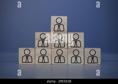 Hierarchical structure, organization and leadership concept. Wooden block pyramid with people icon Stock Photo