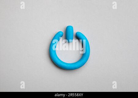 3d plasticine blue start icon on yellow background. Power on off, switch or start and stop button concept. Stock Photo