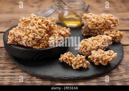 Puffed rice pieces (kozinaki) on wooden table, closeup Stock Photo