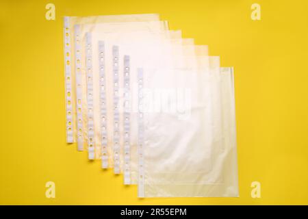 Punched pockets on yellow background, flat lay Stock Photo - Alamy