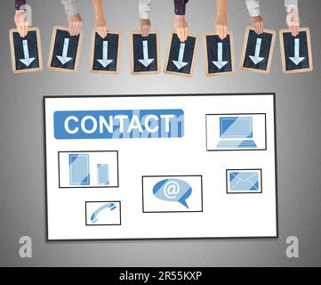 Hands holding writing slates with arrows pointing on contact concept Stock Photo