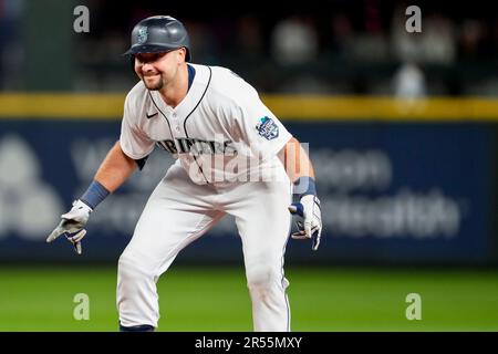 Seattle Mariners' Cal Raleigh reacts after hitting a walk-off single to win  the game 1-0 over the New York Yankees as teammate Julio Rodriguez (44)  runs towards him in a baseball game