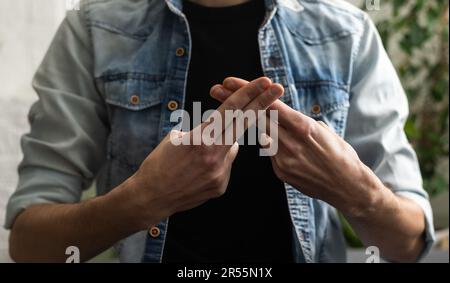 Man showing gesture in sign language on white background Stock Photo