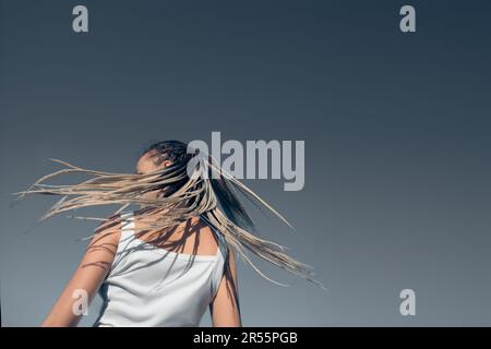 Beautiful woman waving hair with stylish afro braids Stock Photo