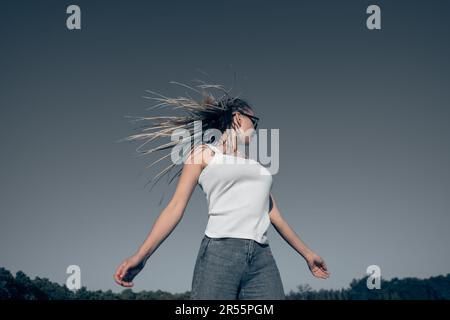 Beautiful woman waving hair with stylish afro braids Stock Photo