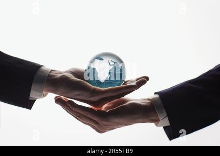 Planet Earth in the hands of businessmen on a white background Stock Photo