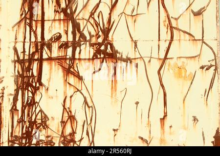 A red brown abstraction of scratched rusty lines and textures on an old weathered metal industrial surface. Random impact marks on a steel wall. Looks Stock Photo