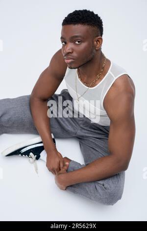 Muscular african american male model in tank top wearing bomber
