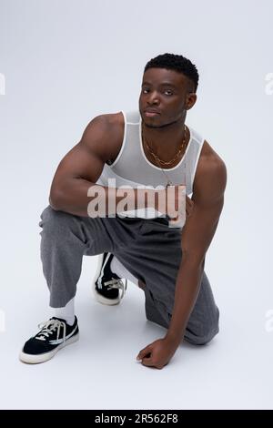 Muscular african american male model in tank top wearing bomber