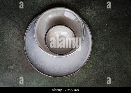 Overhead view of grey ceramic bowls and plates on a table Stock Photo