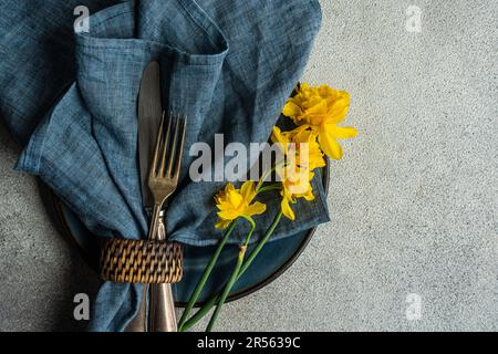 Overhead view of a spring place setting with daffodils Stock Photo
