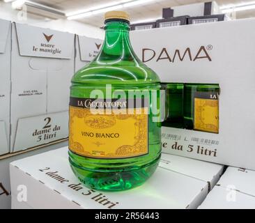 Italy - May 21, 2023: Italian white wine in 5-liter bottle, called in Italian Dama, displayed on cardboard boxes of La Cacciatora brand for sale in It Stock Photo