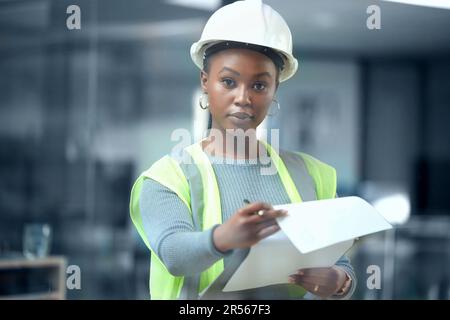 Portrait, engineer and checklist for construction or building inspection, survey and checking logistics on project. Black woman, working on clipboard Stock Photo