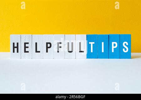 Helpful tips - word concept on building blocks, text Stock Photo