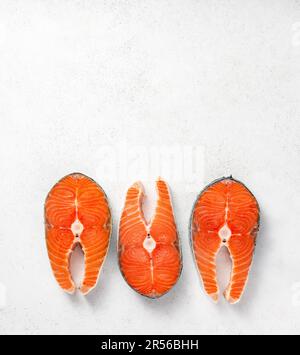 Raw salmon steaks on white background Stock Photo - Alamy