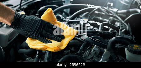 cleaning car engine with microfiber cloth. auto detailing. banner with copy space Stock Photo