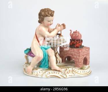 Antique 19thc. Meissen porcelain figure of a child making hot chocolate Stock Photo