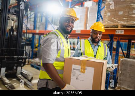 Warehouse workers checking and controlling boxes in warehouse Stock Photo