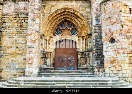 The arched grand entrance of the Church of Santa Maria de la Asuncion with intricately carved stone doorway, adorned with ornate details and decorativ Stock Photo