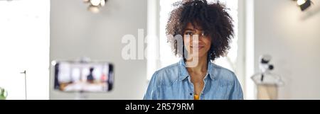 African-American woman designer shoots video for blog at cutting table with tools Stock Photo