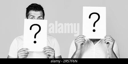 Anonymous man, peeking behind of interrogation symbol. Male incognita. Man a question, anonymous, incognita. Paper notes with question marks. Black Stock Photo