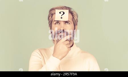 Paper notes with question marks. Beard man question mark in head, solution problems. Man with question mark on forehead looking up Stock Photo