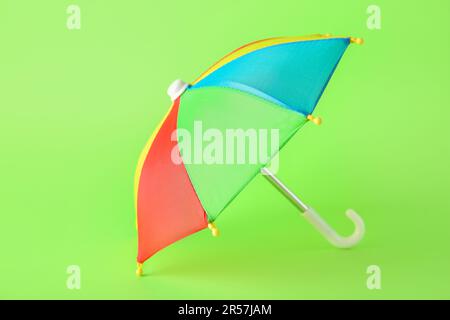 Mini colorful umbrella on green background Stock Photo