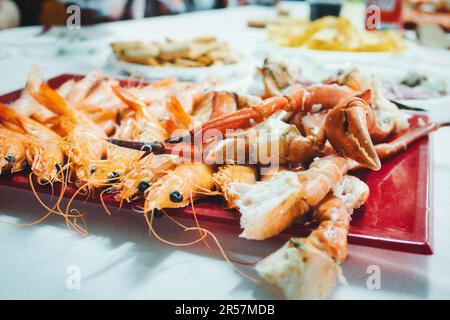 Close-up, wide angle shot of a seafood platter with prawns and crab legs and claws Stock Photo