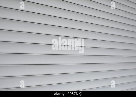 Blinds on window. Plastic shutters. Ribbed surface. Closed windows. Stock Photo