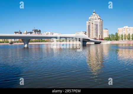 View Of The Modern Pedestrian Atyrau Bridge Over The Ishim River In Astana, The Capital of Kazakhstan. Central Asia Travel Stock Photo