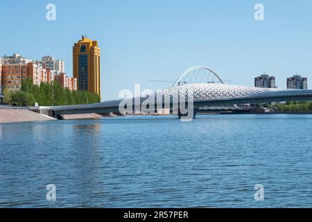 View Of The Modern Pedestrian Atyrau Bridge Over The Ishim River In Astana, The Capital of Kazakhstan. Central Asia Travel Stock Photo
