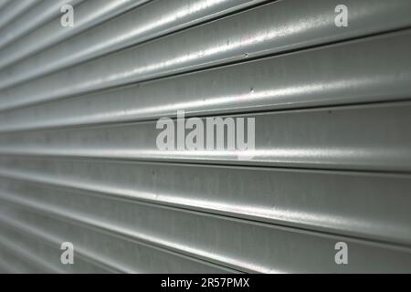 Blinds on window. Plastic shutters. Ribbed surface. Closed windows. Stock Photo