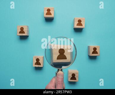 Man with magnifying glass searches for the ideal employee, Job search, employee search, labor market Stock Photo
