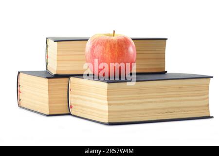 Composition with stack of books and apple isolated on white Stock Photo