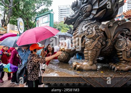 Chinese People Touching Statues For Good Luck At The Wong Tai Sin Temple, Hong Kong, China. Stock Photo