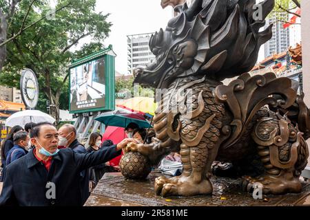 Chinese People Touching Statues For Good Luck At The Wong Tai Sin Temple, Hong Kong, China. Stock Photo