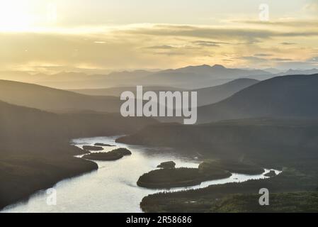 Expansive wilderness views along the Yukon River in Dawson City, Yukon Territory. Gold rush, mining area in arctic Canada at sunset with landscape. Stock Photo