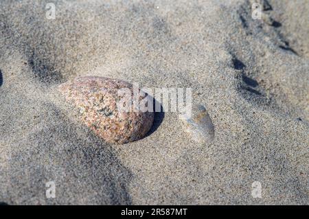 Rocks on the seashore. Waves on the Baltic Sea. The sandy shore of the sea. Stock Photo
