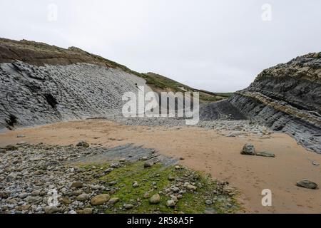 Coastal erosion in Pedruquios beach, sedimentary rocks and landforms eroded by wave action in the cliffs and coastline by the Cantabrian Sea, Costa Qu Stock Photo