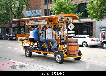 Pittsburgh, PA, USA- May 20, 2023: A crowd enjoys the ride on the Pittsburgh Party Pedaler on Liberty Avenue. These vehicles are powered by the pedali Stock Photo