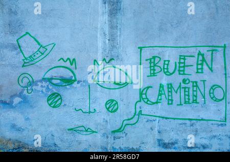 Green Graffiti Buen Camino on a blue wall Stock Photo