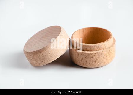 Small wooden round box on white background. Open storage box for small items. Stock Photo