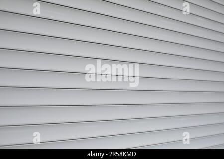 Blinds on window. Plastic shutters. Ribbed surface. Closed windows. Stock Photo