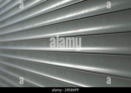 Blinds on window. Plastic shutters. Ribbed surface. Closed windows. Stock Photo