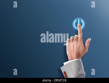 Man pressing start button on blue background, closeup. Space for text Stock Photo